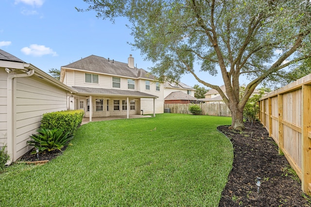 2722 Round Hill Ct, Katy, TX 77494 - back of house with a chimney, a fenced backyard, and a patio