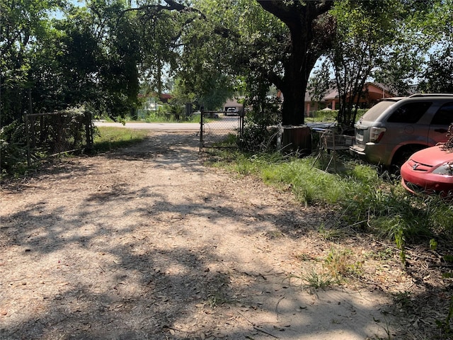 13222 Ann Louise Rd, Houston, TX 77086 - view of dirt / gravel driveway featuring a gated entry