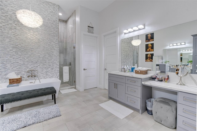 4821 1st St, Houston, TX 77504 - full bath featuring a shower stall, a freestanding tub, vanity, a chandelier, and tile patterned floors
