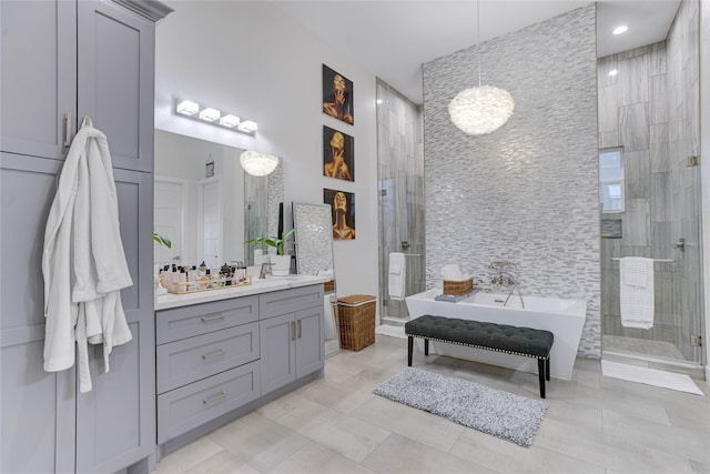 4821 1st St, Houston, TX 77504 - full bathroom featuring a shower stall, vanity, a soaking tub, a chandelier, and tile walls