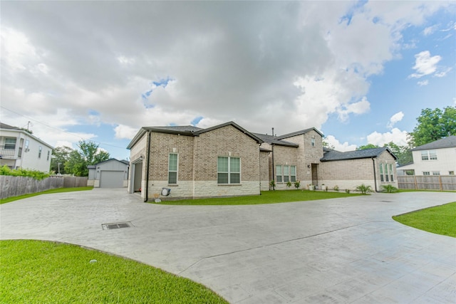 4821 1st St, Houston, TX 77504 - traditional home with brick siding, an outbuilding, a garage, curved driveway, and stone siding