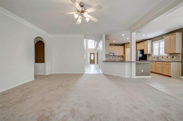 13212 Lismore Pt, Cypress, TX 77429 - kitchen with freestanding refrigerator, stainless steel microwave, light carpet, open floor plan, and ornamental molding