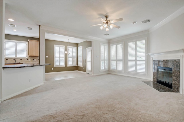 13212 Lismore Pt, Cypress, TX 77429 - unfurnished living room featuring a ceiling fan, light colored carpet, a fireplace, healthy amount of natural light, and ornamental molding