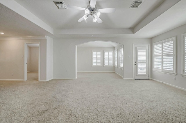 13212 Lismore Pt, Cypress, TX 77429 - carpeted empty room featuring a tray ceiling, a ceiling fan, and arched walkways