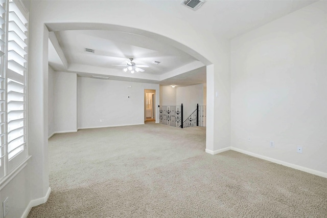 13212 Lismore Pt, Cypress, TX 77429 - unfurnished room with a raised ceiling, arched walkways, light carpet, and ceiling fan