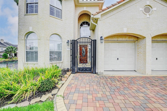13212 Lismore Pt, Cypress, TX 77429 - entrance to property featuring a gate, decorative driveway, and brick siding