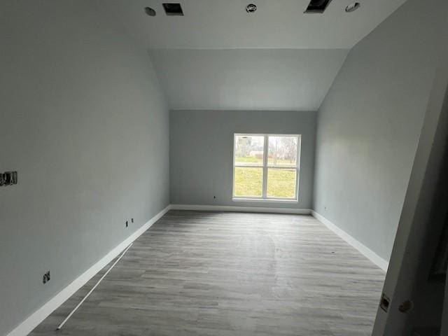 6985 Ellen Ln, Beaumont, TX 77708 - spare room with vaulted ceiling and wood finished floors