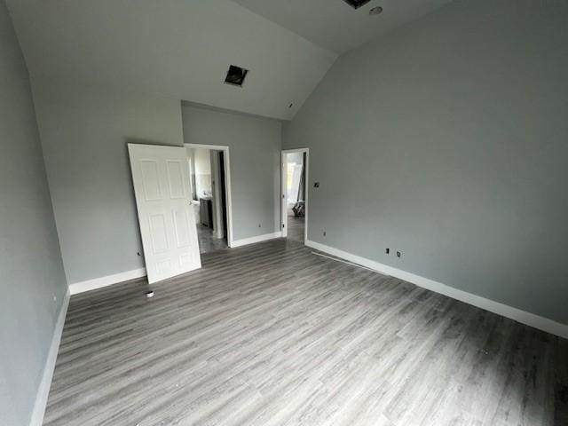 6985 Ellen Ln, Beaumont, TX 77708 - unfurnished bedroom featuring wood finished floors and high vaulted ceiling