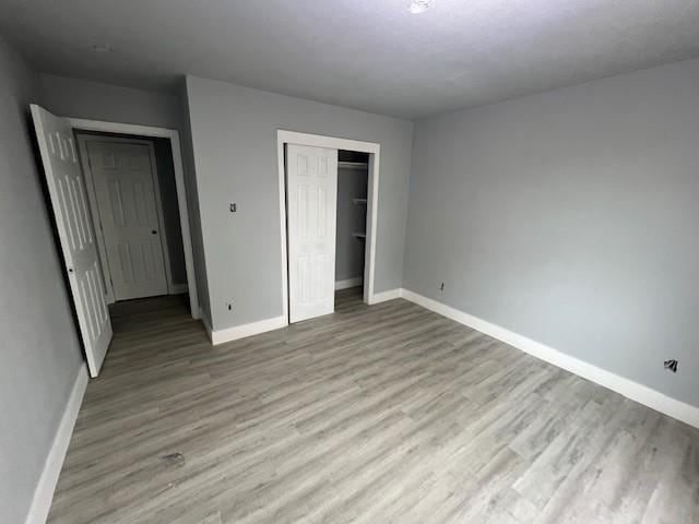6985 Ellen Ln, Beaumont, TX 77708 - unfurnished bedroom featuring light wood finished floors and a closet