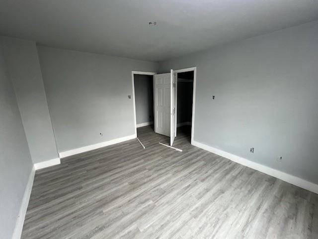 6985 Ellen Ln, Beaumont, TX 77708 - unfurnished bedroom with wood finished floors and a closet
