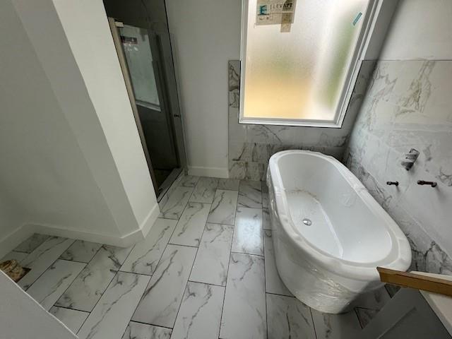 6985 Ellen Ln, Beaumont, TX 77708 - full bath with marble look tile flooring and a soaking tub