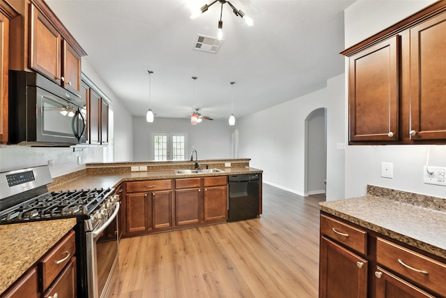 737 Grassy Knoll Ln, La Marque, TX 77568 - kitchen with black appliances, ceiling fan, arched walkways, and light wood-style floors