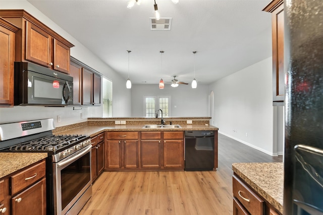 737 Grassy Knoll Ln, La Marque, TX 77568 - kitchen featuring black appliances, a ceiling fan, light wood-style flooring, a peninsula, and pendant lighting