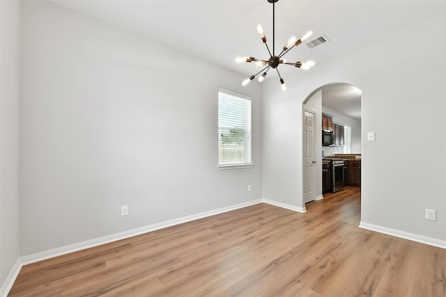 737 Grassy Knoll Ln, La Marque, TX 77568 - empty room with arched walkways, a chandelier, and light wood-type flooring