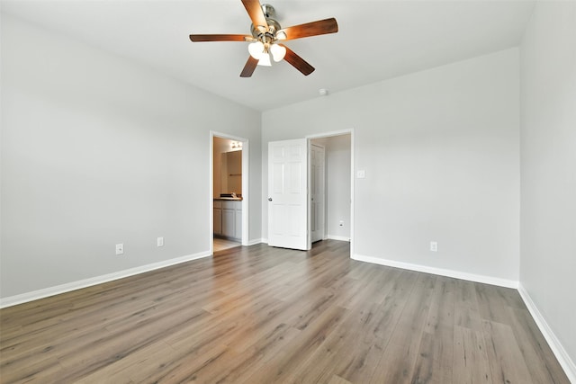 737 Grassy Knoll Ln, La Marque, TX 77568 - unfurnished bedroom featuring wood finished floors, connected bathroom, and a ceiling fan