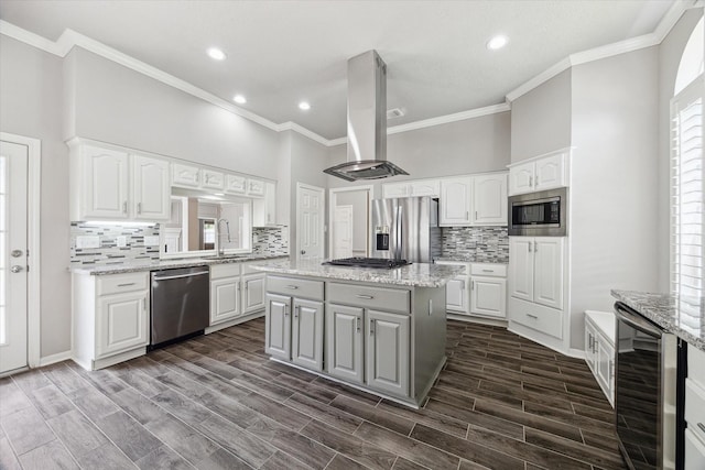 15814 Hillside Falls Trl, Houston, TX 77062 - kitchen with appliances with stainless steel finishes, wine cooler, island range hood, crown molding, and backsplash