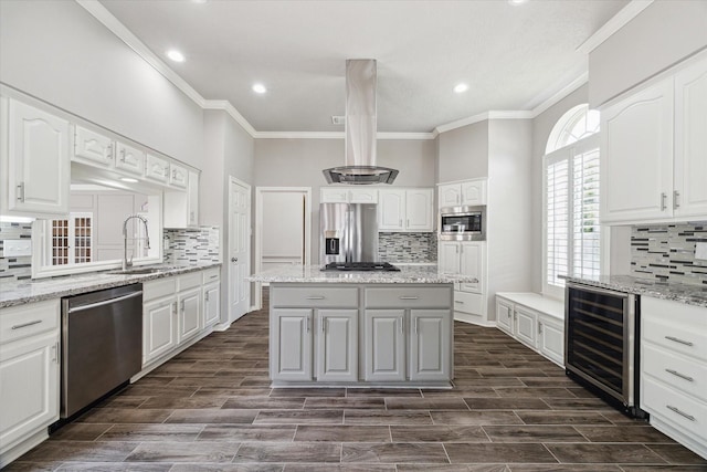 15814 Hillside Falls Trl, Houston, TX 77062 - kitchen featuring wine cooler, appliances with stainless steel finishes, decorative backsplash, ornamental molding, and a center island