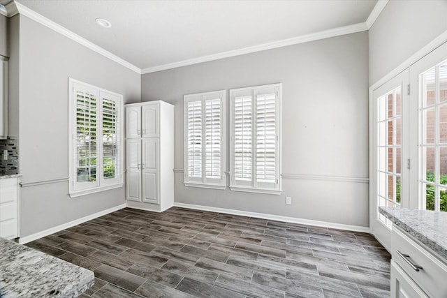 15814 Hillside Falls Trl, Houston, TX 77062 - unfurnished dining area with ornamental molding, plenty of natural light, and dark wood-style flooring