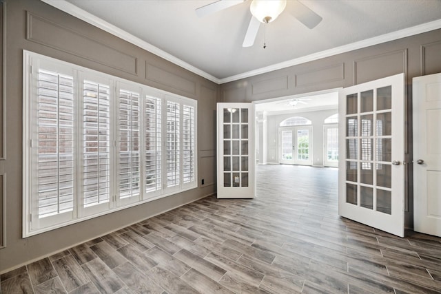 15814 Hillside Falls Trl, Houston, TX 77062 - empty room with french doors, ceiling fan, crown molding, a decorative wall, and wood finished floors