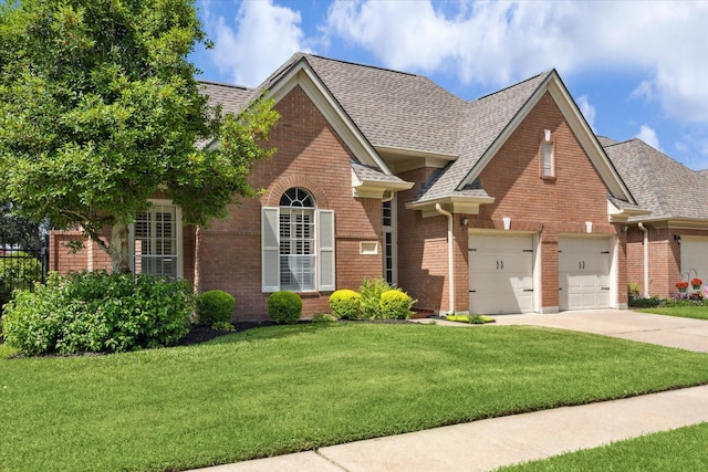 15814 Hillside Falls Trl, Houston, TX 77062 - traditional-style house with brick siding, driveway, a front yard, and a shingled roof