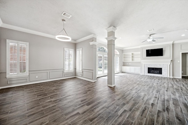 15814 Hillside Falls Trl, Houston, TX 77062 - unfurnished living room featuring ornate columns, ceiling fan, dark wood-type flooring, a textured ceiling, and crown molding