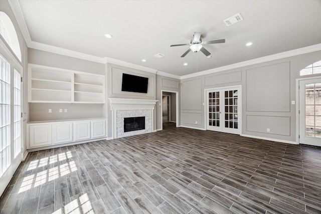 15814 Hillside Falls Trl, Houston, TX 77062 - unfurnished living room with ornamental molding, a ceiling fan, a decorative wall, a fireplace, and wood finished floors
