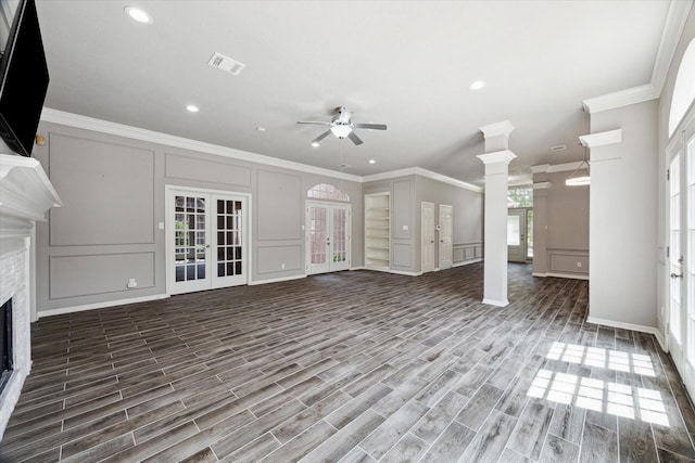 15814 Hillside Falls Trl, Houston, TX 77062 - unfurnished living room featuring a decorative wall, crown molding, french doors, ceiling fan, and a fireplace