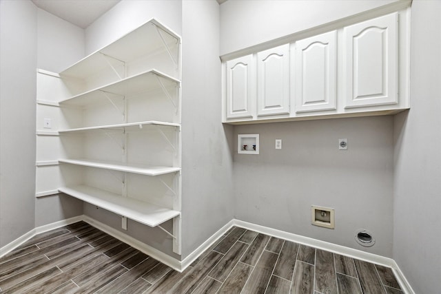15814 Hillside Falls Trl, Houston, TX 77062 - washroom with electric dryer hookup, hookup for a washing machine, dark wood-style flooring, and cabinet space