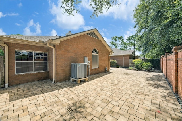 15814 Hillside Falls Trl, Houston, TX 77062 - rear view of house featuring a patio area, brick siding, a fenced backyard, and a chimney