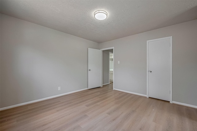 12611 Campsite Trl, Cypress, TX 77429 - empty room with light wood-style floors and a textured ceiling
