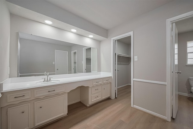 12611 Campsite Trl, Cypress, TX 77429 - full bathroom featuring vanity, wood finished floors, a walk in closet, and recessed lighting
