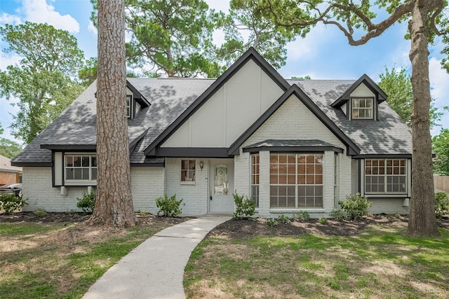 12611 Campsite Trl, Cypress, TX 77429 - english style home featuring a shingled roof and brick siding