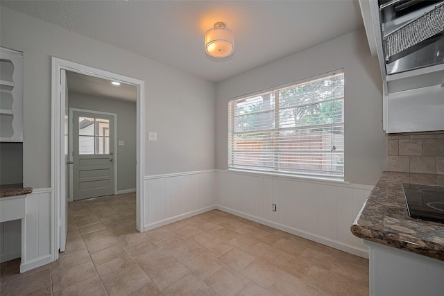 12611 Campsite Trl, Cypress, TX 77429 - unfurnished dining area featuring a wainscoted wall