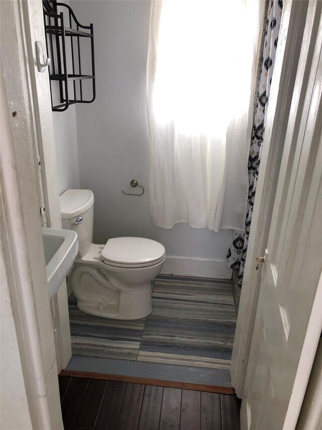 915 11th St, Galveston, TX 77550 - bathroom with toilet and wood finished floors