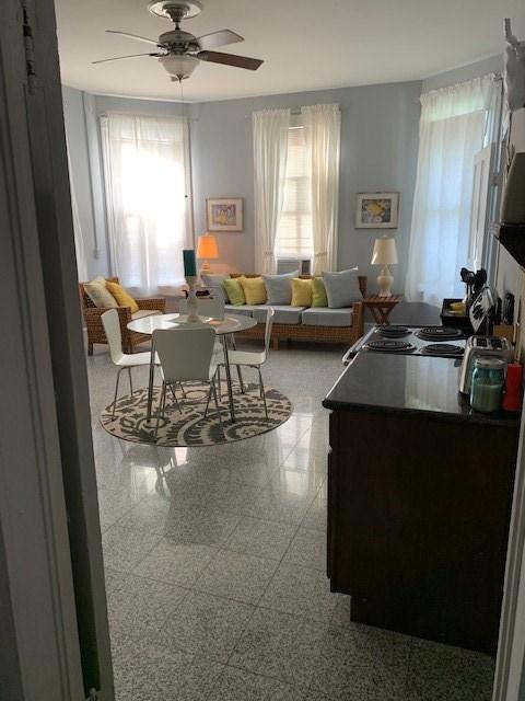 915 11th St, Galveston, TX 77550 - living room featuring plenty of natural light, ceiling fan, and granite floors