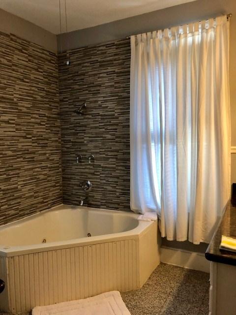 915 11th St, Galveston, TX 77550 - full bathroom with vanity and a combined bath / shower with jetted tub