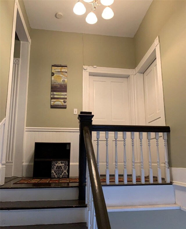915 11th St, Galveston, TX 77550 - staircase with a wainscoted wall and a chandelier
