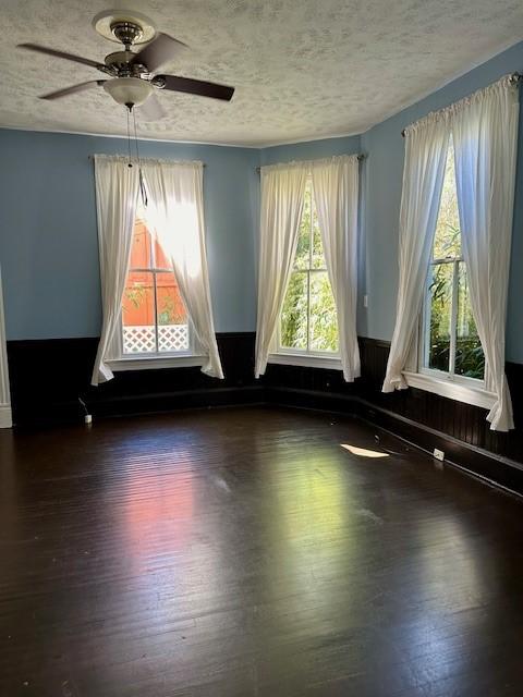 915 11th St, Galveston, TX 77550 - empty room featuring wood finished floors, a textured ceiling, and ceiling fan