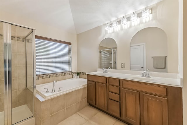 11410 Sandstone Canyon Dr, Humble, TX 77396 - bathroom featuring a garden tub, a shower stall, double vanity, vaulted ceiling, and tile patterned flooring