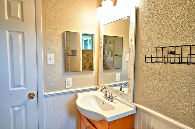 7354 Stone Pine Ln, Houston, TX 77041 - bathroom featuring a wainscoted wall, vanity, and a textured wall