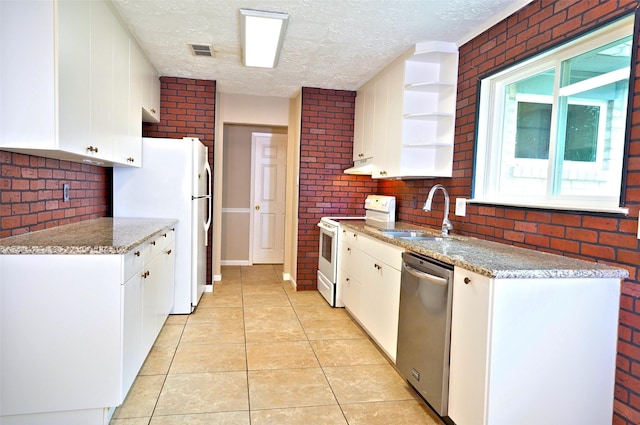 7354 Stone Pine Ln, Houston, TX 77041 - kitchen with white appliances, brick wall, light tile patterned floors, a textured ceiling, and open shelves