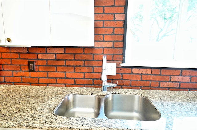 7354 Stone Pine Ln, Houston, TX 77041 - kitchen view of white cabinetry, light stone counters, and tasteful backsplash