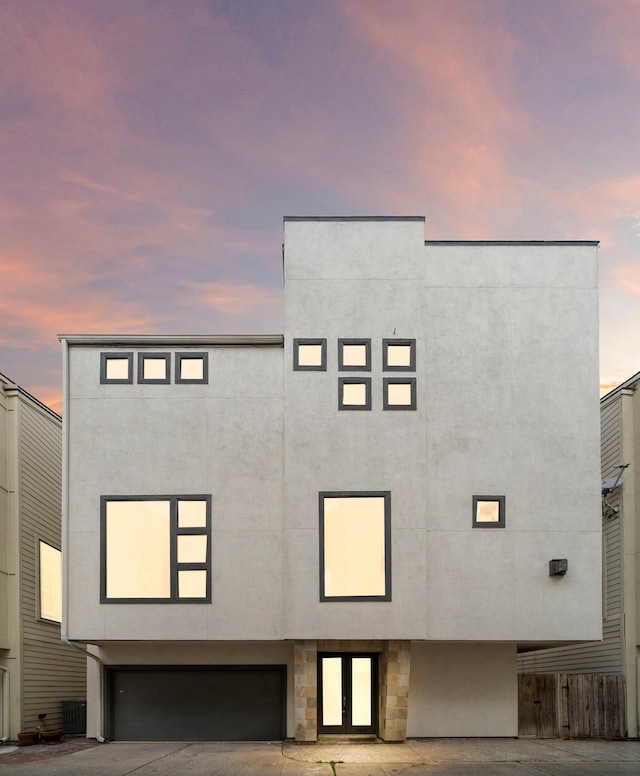 906 Reinerman St, Houston, TX 77007 - view of front facade featuring a garage, stucco siding, and french doors