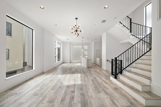 906 Reinerman St, Houston, TX 77007 - foyer with light wood finished floors, a chandelier, stairway, and recessed lighting
