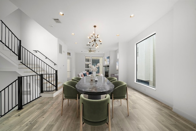 906 Reinerman St, Houston, TX 77007 - dining space with a chandelier, light wood-type flooring, stairway, and recessed lighting