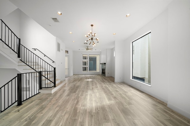 906 Reinerman St, Houston, TX 77007 - unfurnished living room featuring a chandelier, light wood-style floors, recessed lighting, and stairway