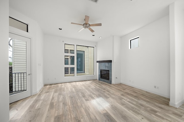906 Reinerman St, Houston, TX 77007 - unfurnished living room with light wood-style floors, a glass covered fireplace, a ceiling fan, and recessed lighting