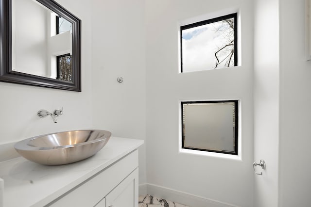 906 Reinerman St, Houston, TX 77007 - bathroom featuring vanity and marble look tile flooring