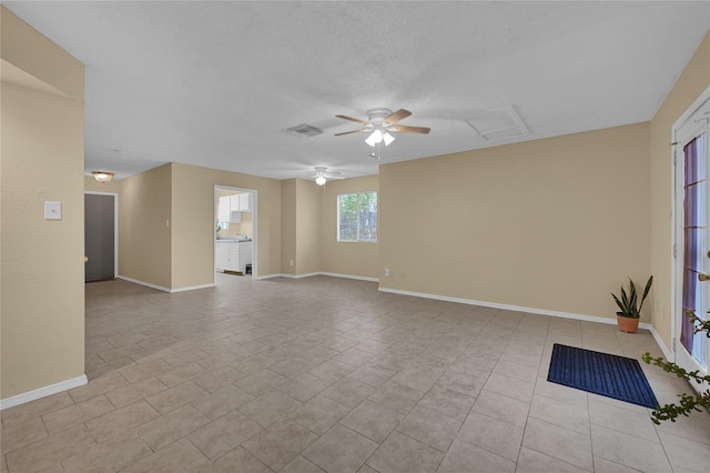 8405 Wilcrest Dr Unit 2800, Houston, TX 77072 - spare room featuring a ceiling fan, light tile patterned floors, and attic access