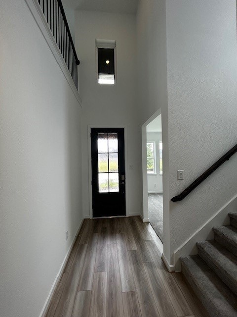 1123 Buffalo Run, Tomball, TX 77375 - entrance foyer featuring stairway, wood finished floors, and a towering ceiling